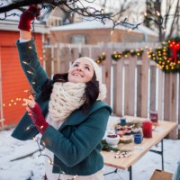 happy woman decorating backyard with illuminated lighting equipments - garden decoration stock pictures, royalty-free photos & images