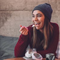 happy woman eating healthy sweet snack - food stock pictures, royalty-free photos & images