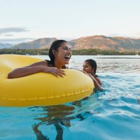 happy woman enjoying with friends in swimming pool - travel stock pictures, royalty-free photos & images