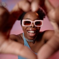 happy woman gesturing heart shape with fingers - fashion stock pictures, royalty-free photos & images