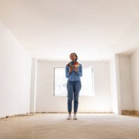 happy woman remodeling her house and choosing a color for the walls - home decoration stock pictures, royalty-free photos & images