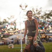 happy woman sitting on boyfriend's shoulders - concert stock pictures, royalty-free photos & images