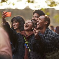 happy woman taking selfie with friends through smart phone - concert stock pictures, royalty-free photos & images