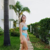 happy woman walking in tropical garden among palm trees - garden decoration stock pictures, royalty-free photos & images