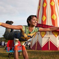 happy woman with arms outstretched balancing on legs - concert stock pictures, royalty-free photos & images
