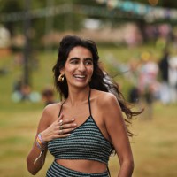 happy woman with hand on chest walking at park - concert stock pictures, royalty-free photos & images