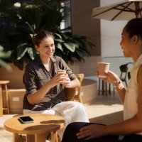 happy women talking in coffee shop. - coffee stock pictures, royalty-free photos & images