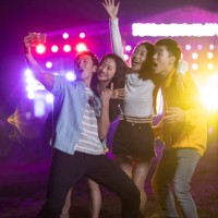 happy young chinese friends taking selfie at music festival - concert stock pictures, royalty-free photos & images