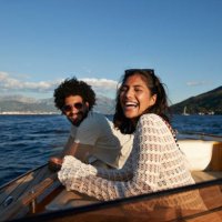 happy young couple enjoying in motorboat - travel stock-fotos und bilder