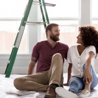 happy young couple take break from diy project - home decoration stock pictures, royalty-free photos & images