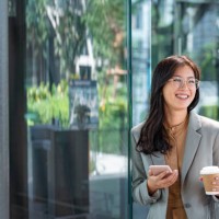 happy young elegant asian businesswoman texting on her smartphone on the go - junk food stock pictures, royalty-free photos & images
