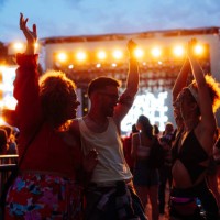 happy young friends dancing at music festival at night - concert stock pictures, royalty-free photos & images
