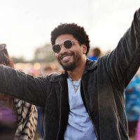 happy young man dancing with arms raised - concert stock pictures, royalty-free photos & images