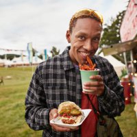 happy young man eating take out street food - concert stock pictures, royalty-free photos & images