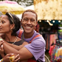 happy young man hugging girlfriend from behind - concert stock pictures, royalty-free photos & images