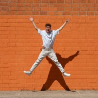 happy young man jumping mid-air - fashion stock pictures, royalty-free photos & images