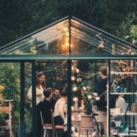 happy young multi-ethnic group enjoying dinner party in conservatory at back yard - garden decoration stock pictures, royalty-free photos & images