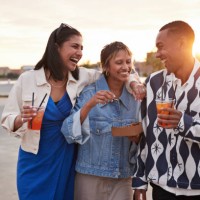 happy young multiracial friends enjoying food and drinks - junk food stock pictures, royalty-free photos & images