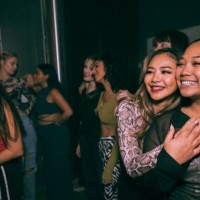 happy young woman embracing friend enjoying at nightclub - concert stock pictures, royalty-free photos & images
