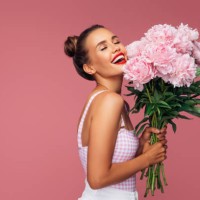 happy young woman holding bouquet of pink flowers - fashion stock pictures, royalty-free photos & images