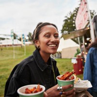 happy young woman holding street food - concert stock pictures, royalty-free photos & images
