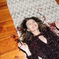 happy young woman in glittering cocktail dress on carpet floor, flash light, user generated content - fashion stock pictures, royalty-free photos & images
