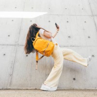 happy young woman jumping against wall. - fashion stock pictures, royalty-free photos & images