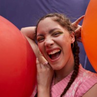 happy young woman with red and orange balloons - fashion stock pictures, royalty-free photos & images