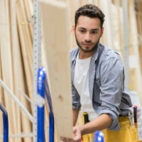 hardware store employee loads lumber onto a dolly - home decoration stock pictures, royalty-free photos & images