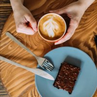having a little break with a cup of latte and white chocolate brownie - coffee stock pictures, royalty-free photos & images