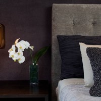headboard detail with pillows lamp and orchid flowers - home decoration stock pictures, royalty-free photos & images