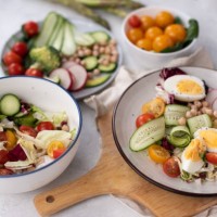 healthy detox dish with egg, avocado, quinoa, spinach, fresh tomato, green peas and broccoli on white wooden background, top view - food stock pictures, royalty-free photos & images