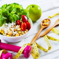 healthy eating and exercising backgrounds: fresh healthy salad, dumbbells and tape measure with copy space - junk food stock pictures, royalty-free photos & images