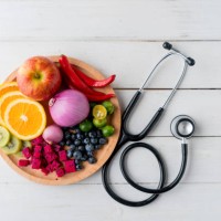 healthy food in heart dish with doctor's stethoscope - food stock pictures, royalty-free photos & images