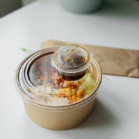 healthy food lunch in kraft paper carton. concept of eco friendly disposable dish. chicken, corn, tomatoes, celery and sause. take away delivery. environment protection - junk food stock pictures, royalty-free photos & images