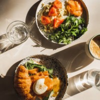 healthy, organic and natural breakfast. croissant, salmon, poached egg, greens, tomato, omelette. glass of water and coffee cup - food stock pictures, royalty-free photos & images