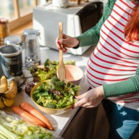 healthy pregnant woman preapring a fresh organic salad for her breakfast - food stock pictures, royalty-free photos & images