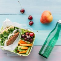 healthy school food in a lunch box, vegetarian sandwich with cheese, lettuce, cucumber, egg and cress, sliced carrot and celery, cherries and pear - junk food stock pictures, royalty-free photos & images