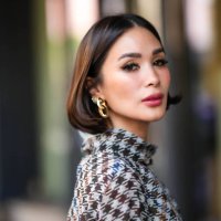 Heart Evangelista wears golden earrings, a houndstooth pattern printed dress, outside Carolina Herrera, during New York Fashion Week, on September...
