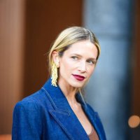 Helena Bordon wears a brown / orange top, a blue denim jacket, gold earrings, outside Zimmermann, during the Womenswear Fall/Winter 2024/2025 as part...