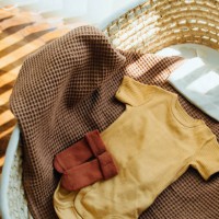 high angle shot of baby clothings and accessories in moses basket. precious moment in life. preparation for a new family member. expecting a new life concept. baby and new life concept - fashion stock pictures, royalty-free p