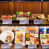 high angle view of a selection of bento boxes with traditional japanese foods on shelves. - junk food stock pictures, royalty-free photos & images