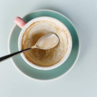 high angle view of an empty glass cup of coffee on table in cafe shop against a white backgrounds - junk food stock pictures, royalty-free photos & images