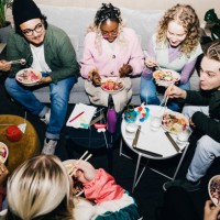 high angle view of multiracial male and female students enjoying food in college dorm - food stock pictures, royalty-free photos & images