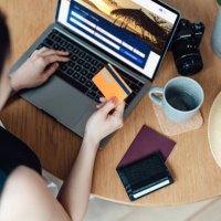 high angle view of young woman booking flight tickets online using laptop - travel stock pictures, royalty-free photos & images