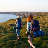hikers walking along coastal path - travel stock pictures, royalty-free photos & images