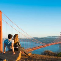 hispanic couple admiring golden gate bridge, san francisco, california, united states - travel stock-fotos und bilder