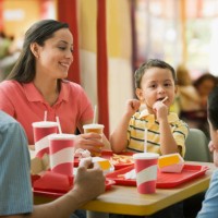 hispanic family eating in fast food restaurant - junk food stock pictures, royalty-free photos & images