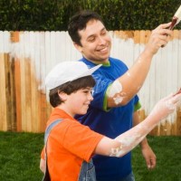 hispanic father and son painting fence - garden decoration stock pictures, royalty-free photos & images
