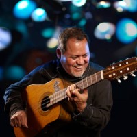 hispanic man playing guitar for crowd - concert stock pictures, royalty-free photos & images